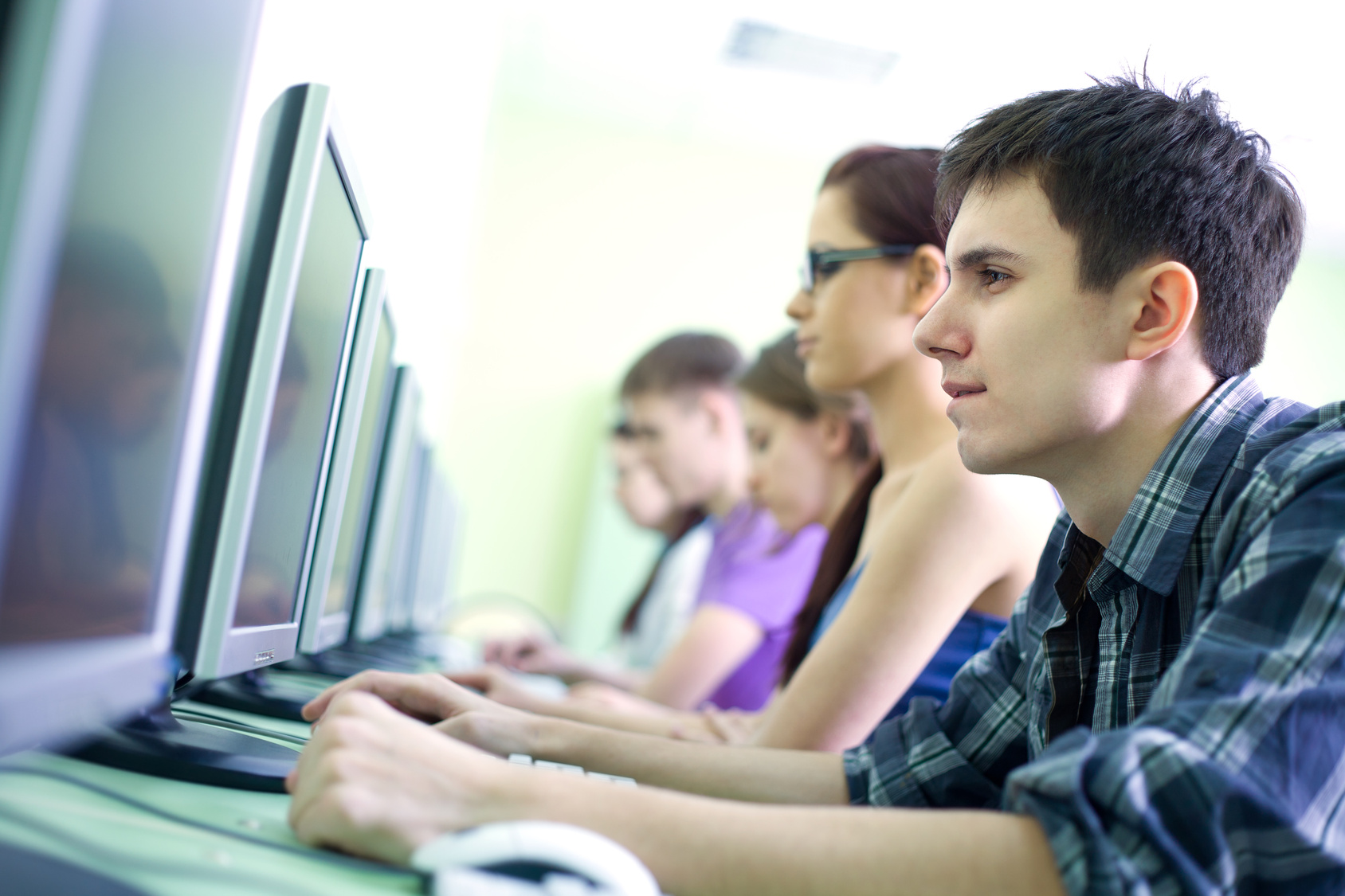 group of teens in internet-cafe with computers